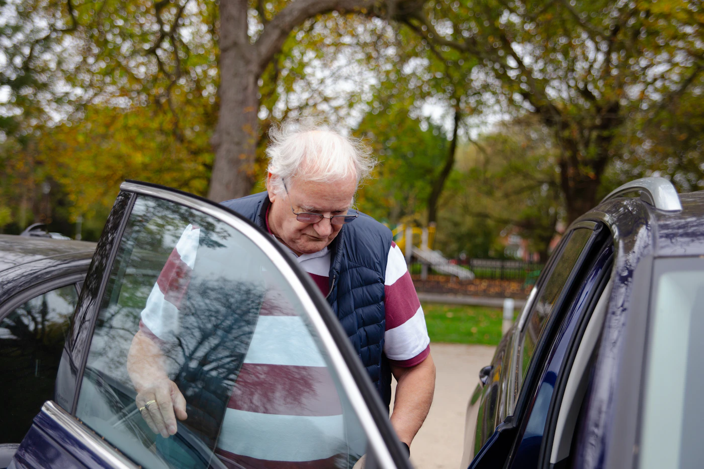 An elderly man being welcomed back into the car after his appointment